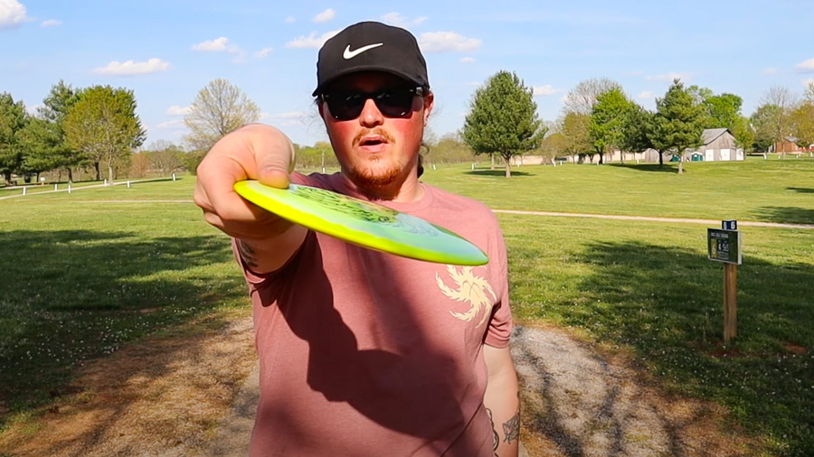 A disc golfer demonstrating a hyzer angle